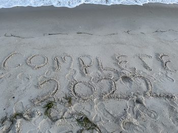 Complete 2022 written in the sand at beach